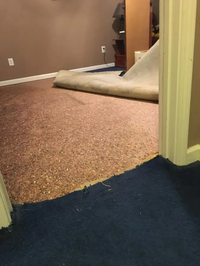 Carpet pad removal revealing water damage during Water Mitigation Services in Avra Valley